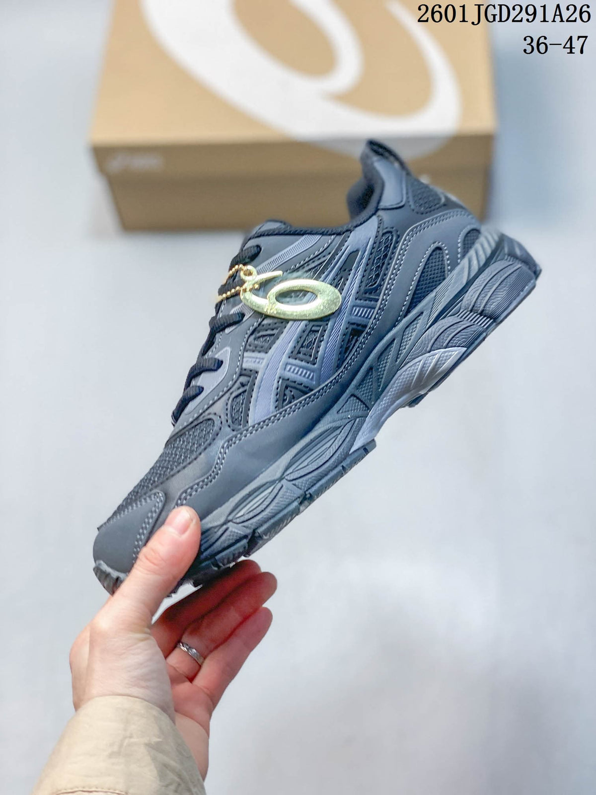 Side view showing the layered gray upper, mesh panels, and textured sole.