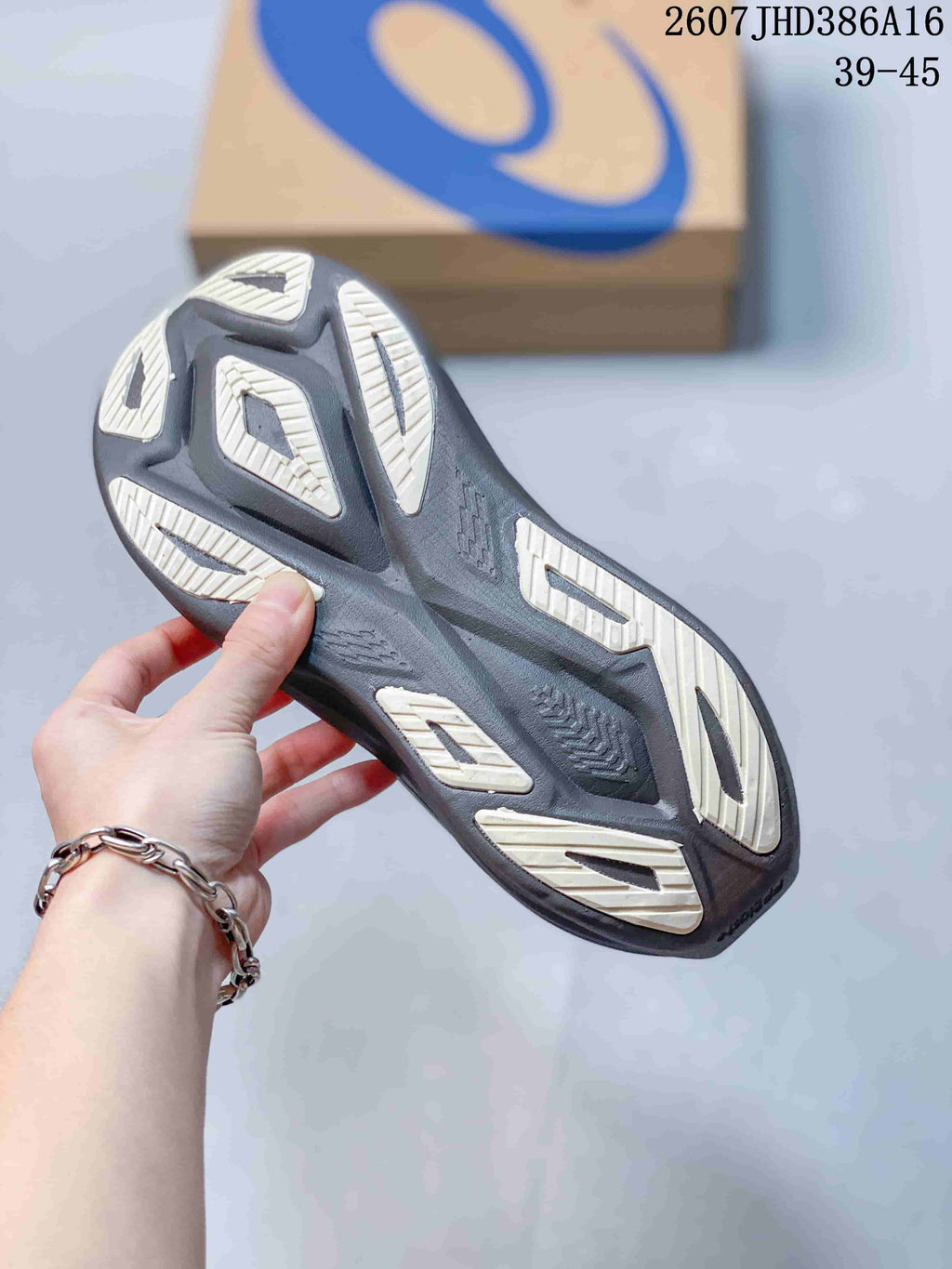 Bottom view of the sneaker showing the sculpted outsole with light-colored traction sections.