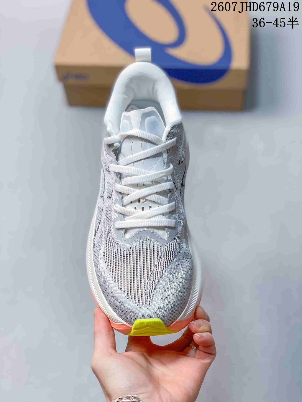 Top view of a gray and white ASICS Superblast 2 running shoe with white laces and lime toe accent.