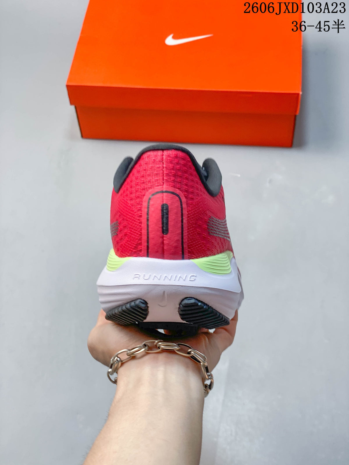 Rear view of a red running shoe with a white midsole and lime heel accent