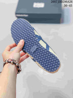Close view of the patterned navy rubber outsole on a cream and navy Onitsuka Tiger sneaker; image text shows size range 36-45.