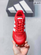 Top view of the red lace-up sneaker showing the tongue, eyelets, stitching, and white side stripes.