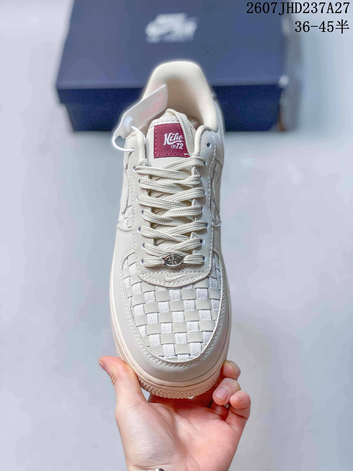 Top view showing the woven toe box, tonal laces, and burgundy tongue label.