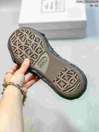 Close view of the sneaker outsole showing a repeating raised geometric pattern and textured tread.