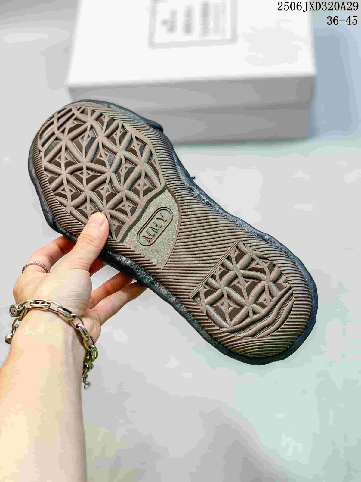 Close view of the sneaker outsole showing a repeating raised geometric pattern and textured tread.