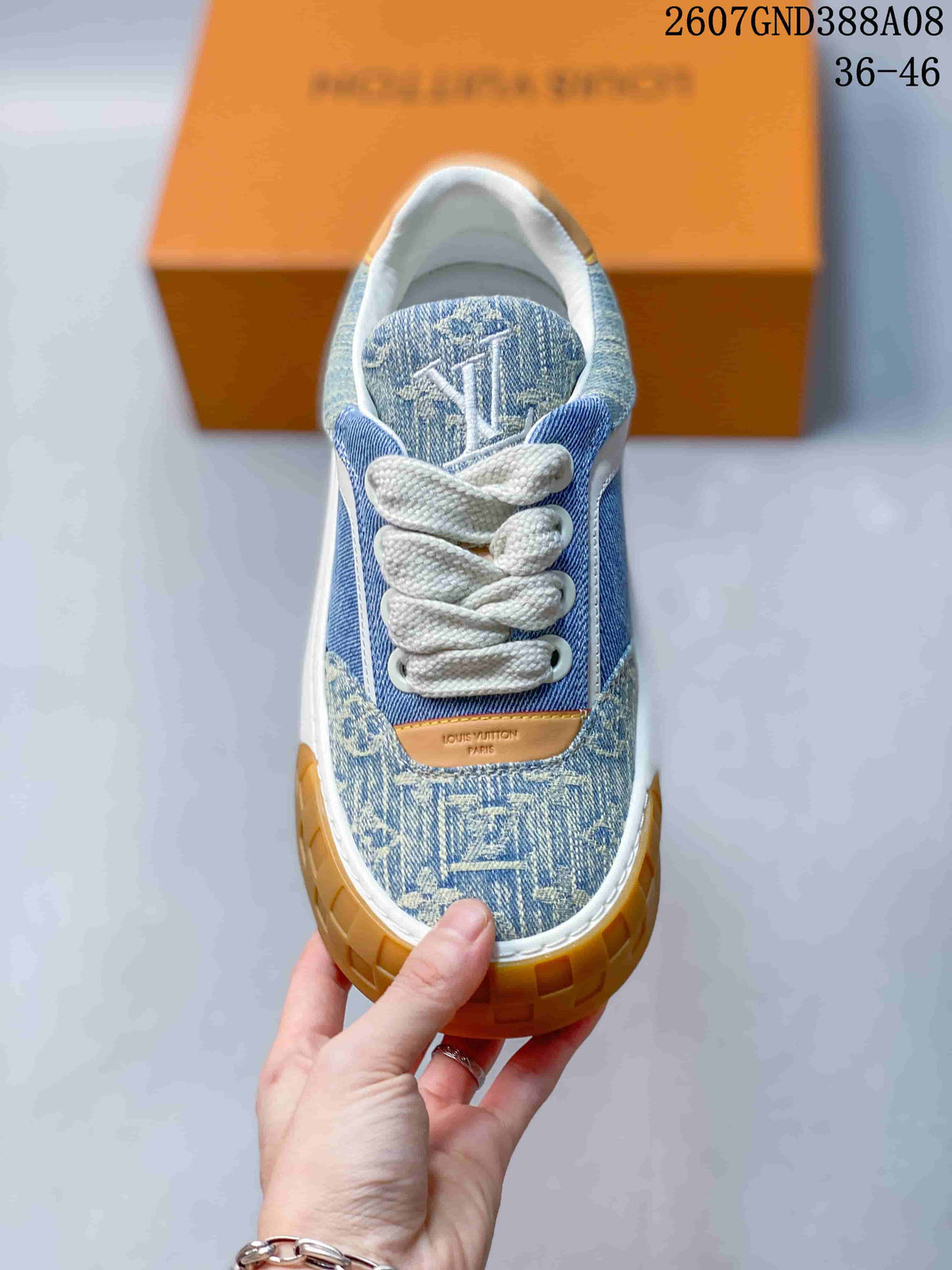 Top view showing the patterned toe, white laces, tongue branding, and rounded toe shape.