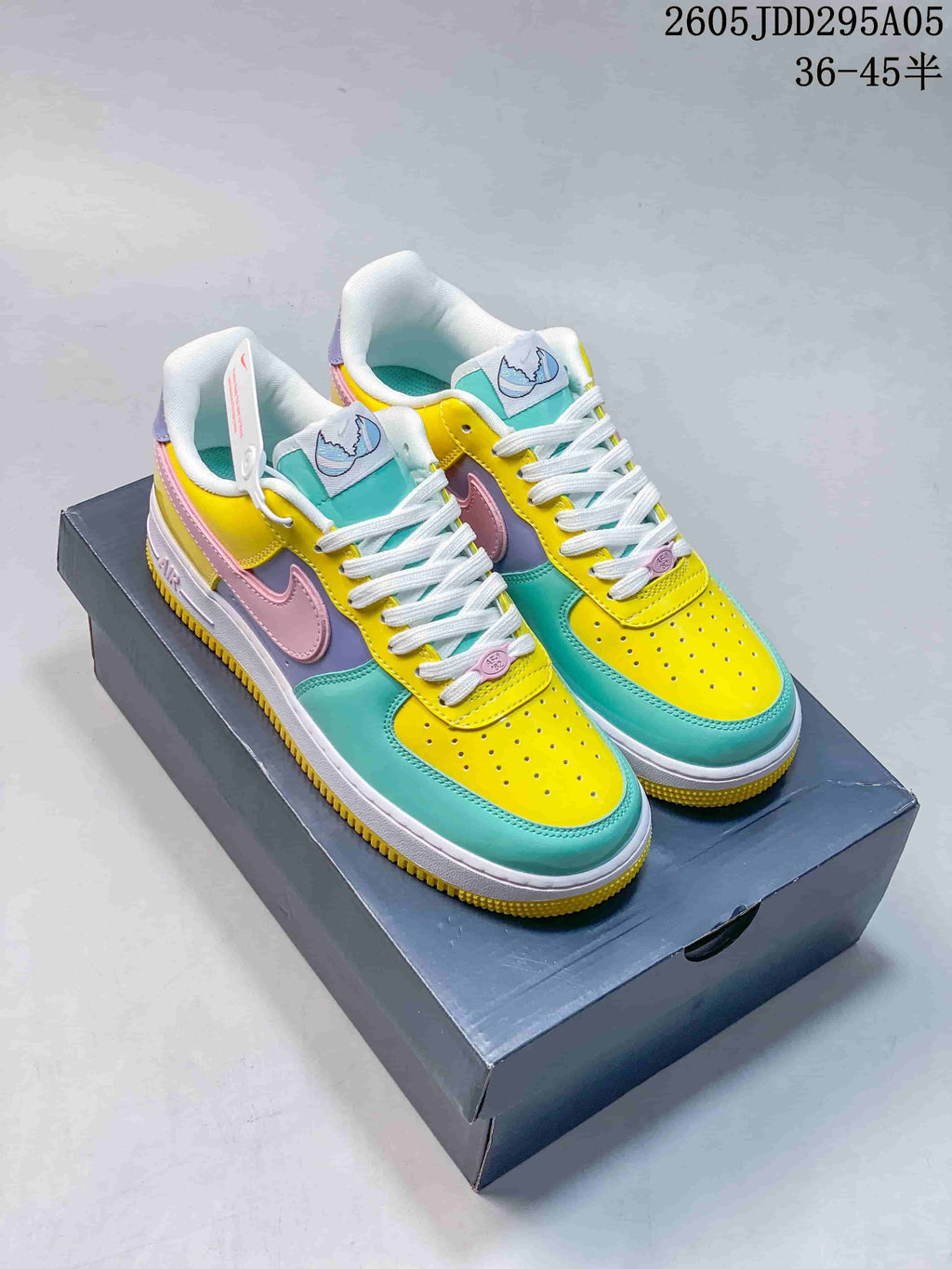 Pair of multicolor Nike Air Force 1 low-top sneakers displayed on a shoebox, with yellow, turquoise, pink and lavender panels; overlay text shows 36–45 half sizes.
