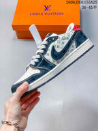 Side profile showing the patterned upper, dark overlays, contrasting swoosh-shaped panel and layered sole.