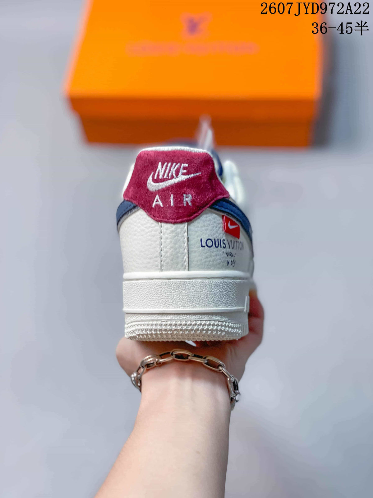 Rear view of the sneaker showing the red-and-white tongue detail, white heel panel, and visible Louis Vuitton reference text.