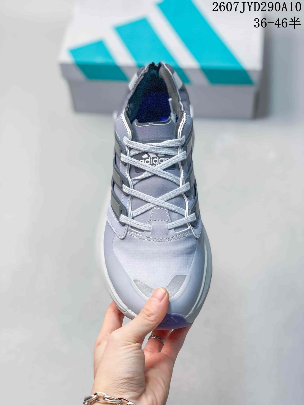 Top view of the adidas shoe showing the gray upper, light-colored laces, padded collar and contrasting toe details.