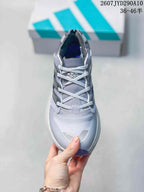 Top view of the adidas shoe showing the gray upper, light-colored laces, padded collar and contrasting toe details.