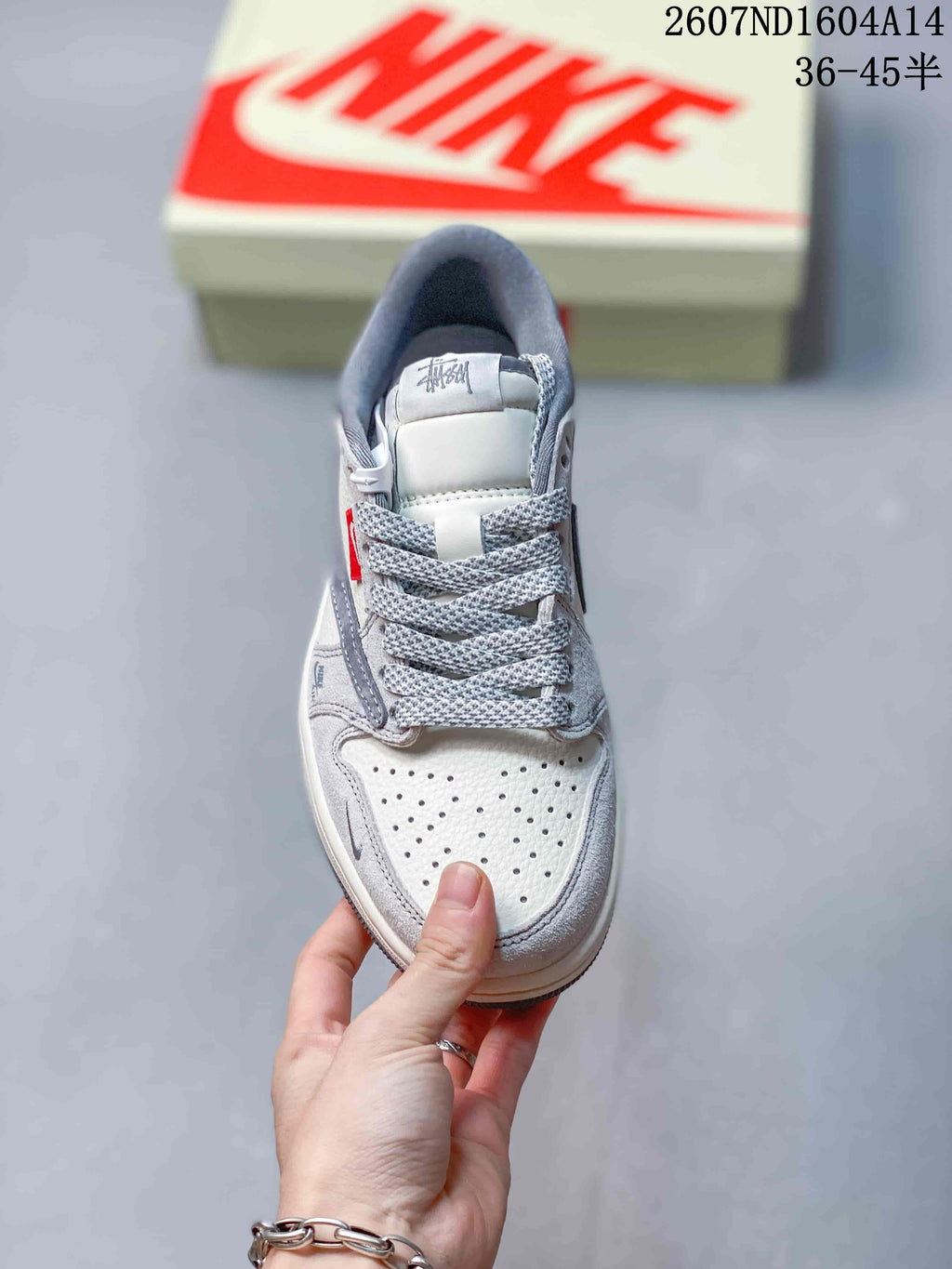 Top view showing the perforated off-white toe box, gray overlays, padded tongue, and patterned laces.