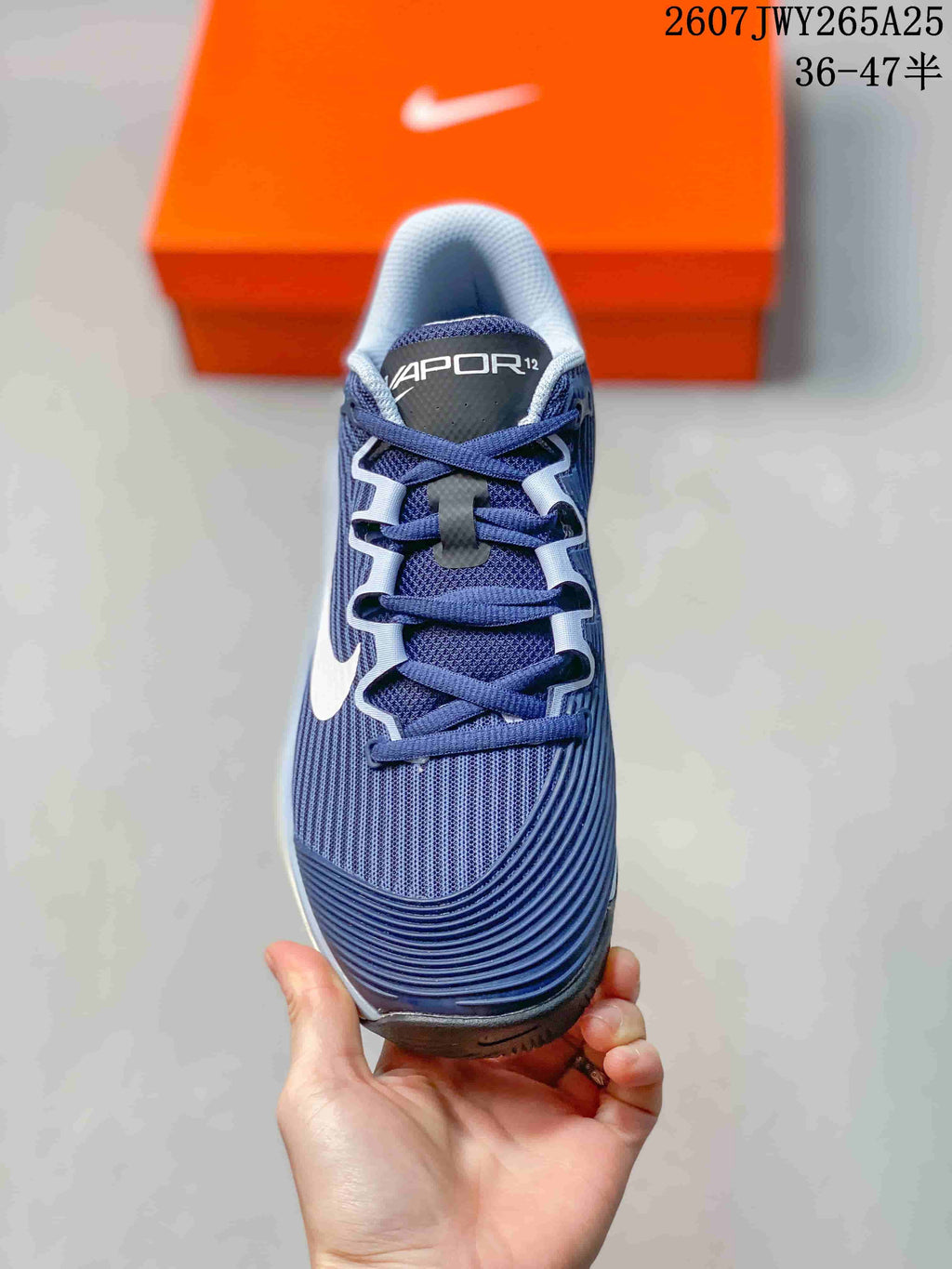 Top view of a navy Nike Vapor 12 shoe showing the lace-up construction, padded tongue, and textured forefoot.