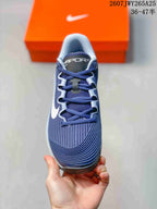 Top view of a navy Nike Vapor 12 shoe showing the lace-up construction, padded tongue, and textured forefoot.