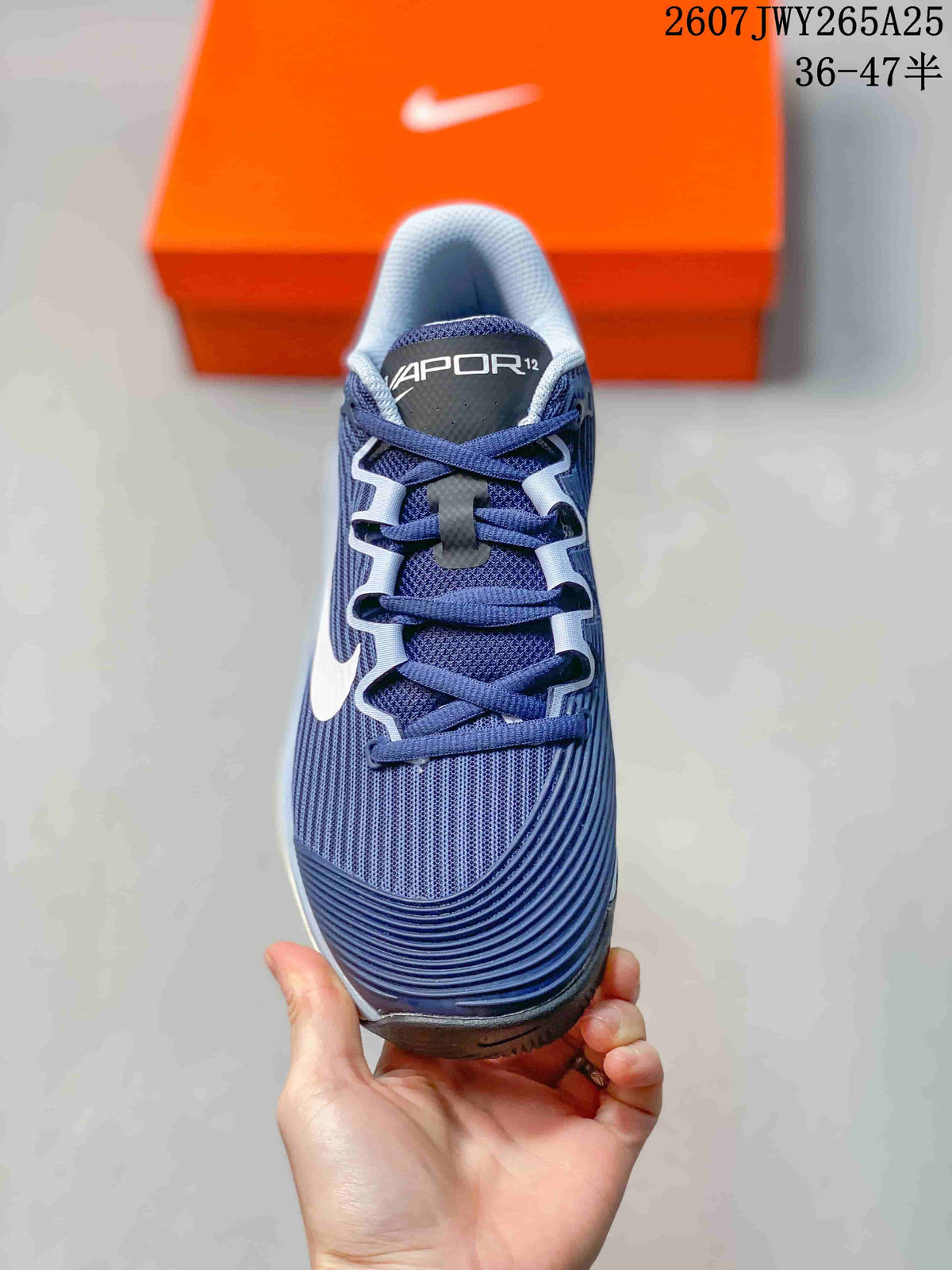 Top view of a navy Nike Vapor 12 shoe showing the lace-up construction, padded tongue, and textured forefoot.