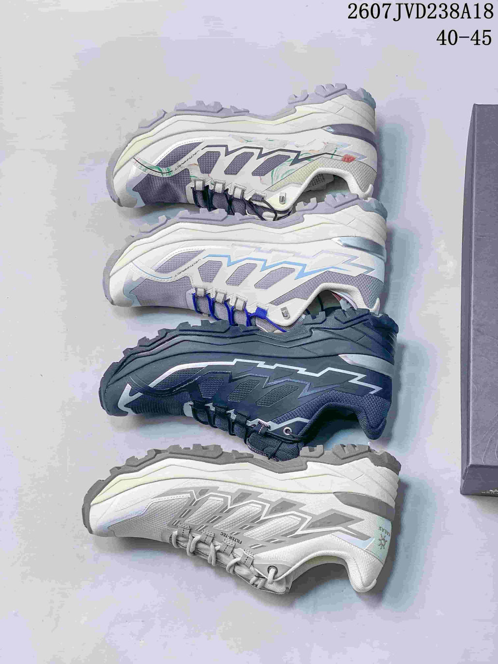 Top-down display of four KAILAS hiking shoe colorways, including light gray, white with blue accents, dark charcoal, and white with gray accents.