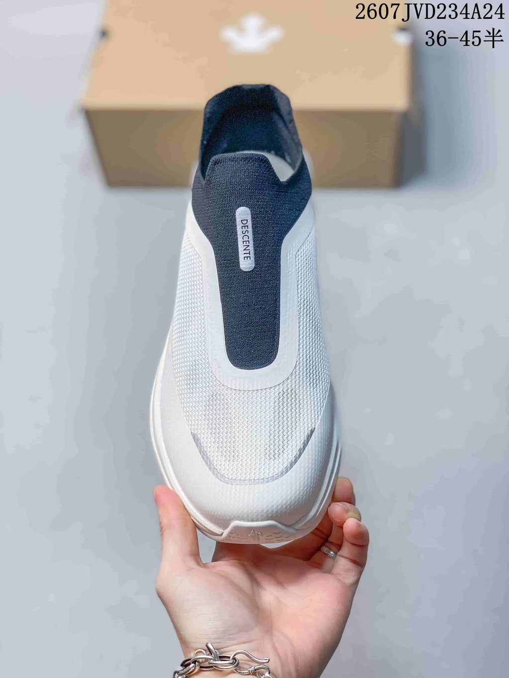 Top view showing the lace-free opening, navy central panel and textured white upper.