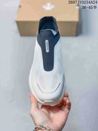 Top view showing the lace-free opening, navy central panel and textured white upper.