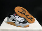 Angled view showing the gum-colored outsole and black tread markings on the raised shoe.