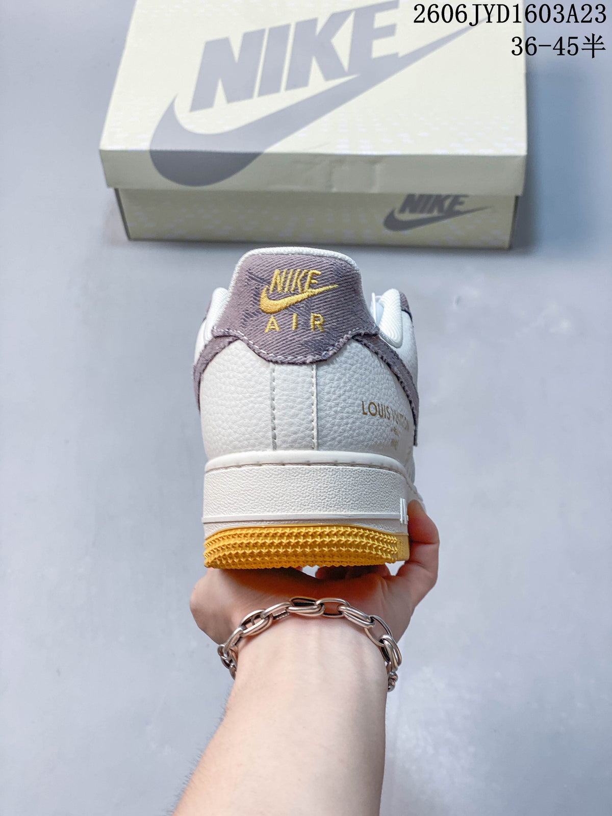 Rear view showing the ivory heel, mauve heel tab, and gum-yellow outsole.
