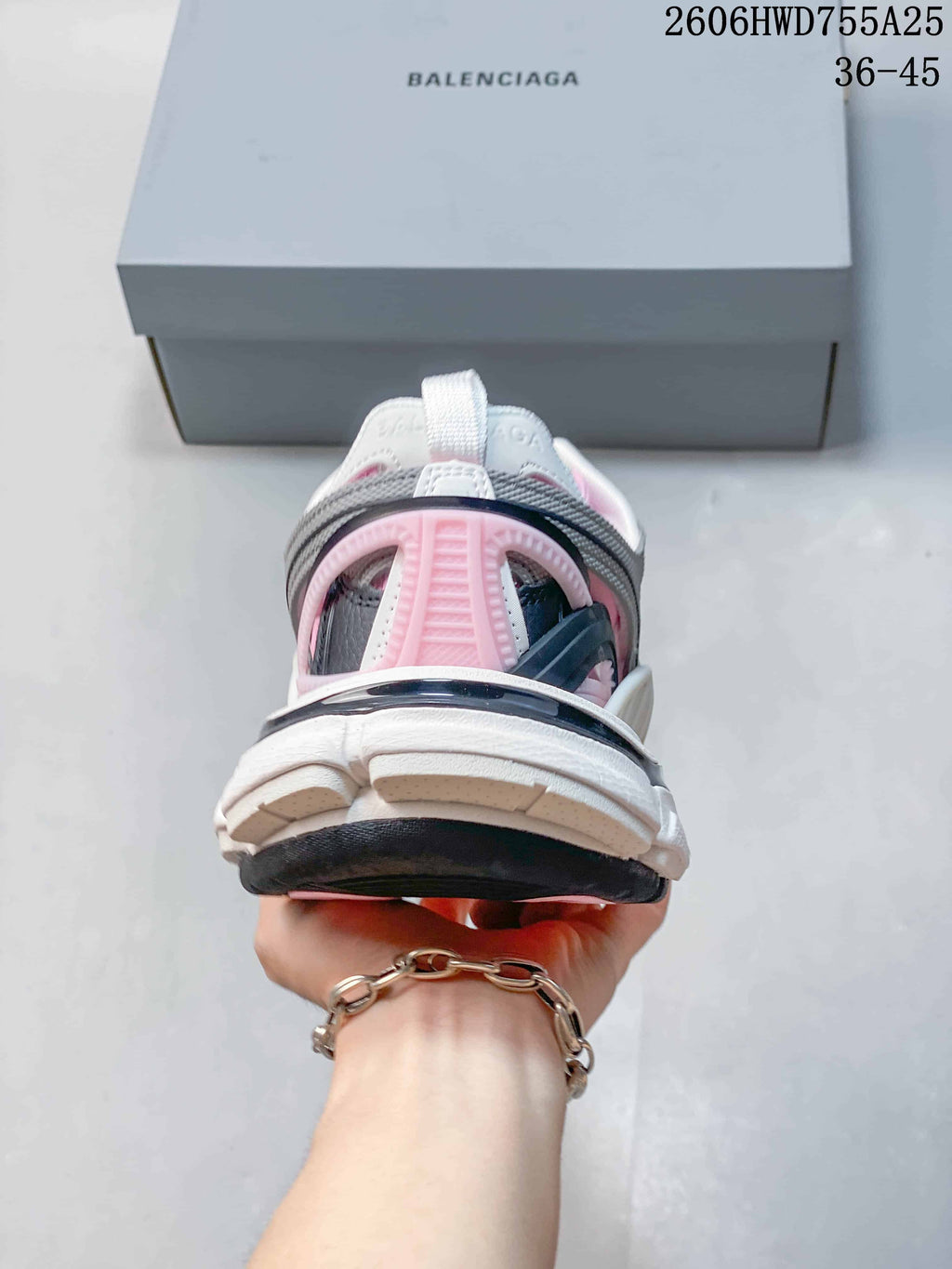Rear view of a white, pink, and gray Balenciaga Track 2 sneaker; an image overlay shows a 36–45 size range.