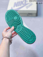 Close-up of the green rubber outsole showing circular and segmented tread patterns.