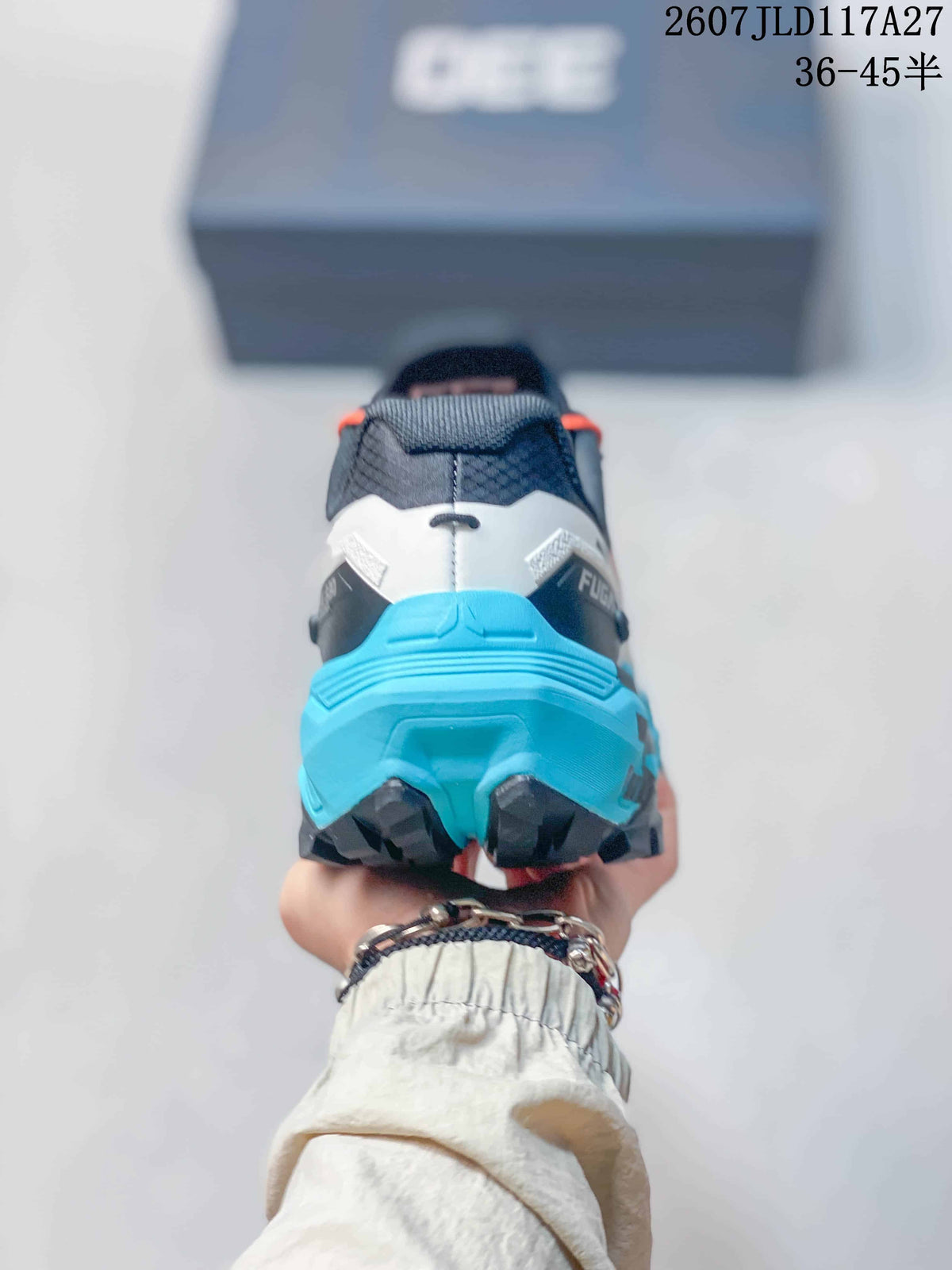 Rear view showing the teal heel structure, black outsole sections, and FUGA branding.