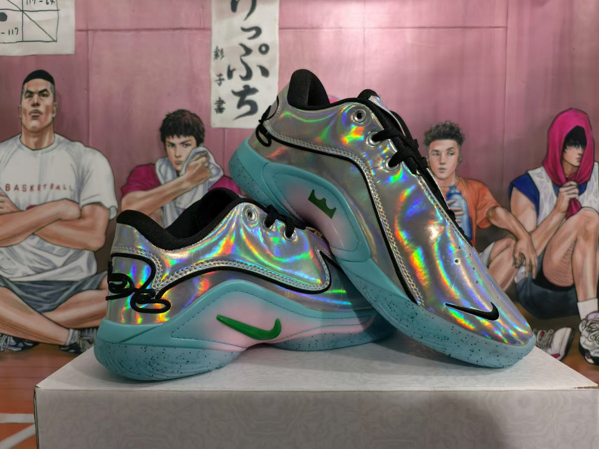 Pair of silver holographic basketball shoes with turquoise outsoles and green Swoosh accents