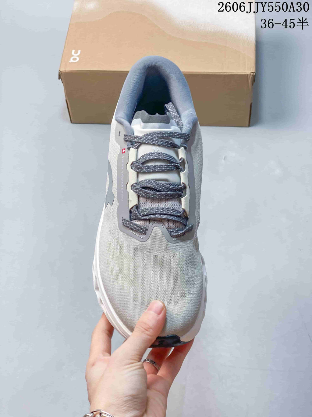 Top view of the shoe showing its laces and light gray upper