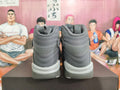 Rear view of grey Jordan high-top sneakers showing padded collars and layered heel details.