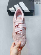 Top view of a pink Adidas sneaker showing its crossed strap closures