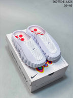 Pair of white Nike Mind 001 closed-toe slides displayed on a Nike Mind box; size range text is visible in the upper-right corner.