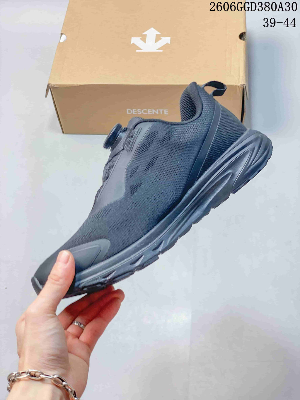 Side view of a dark gray low-top shoe with dial closure