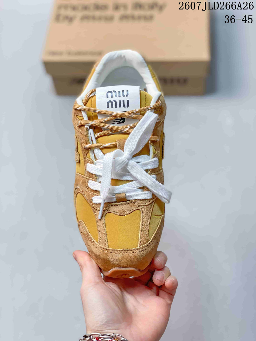 Top view of the sneaker showing white laces, tan secondary laces and a Miu Miu tongue label.