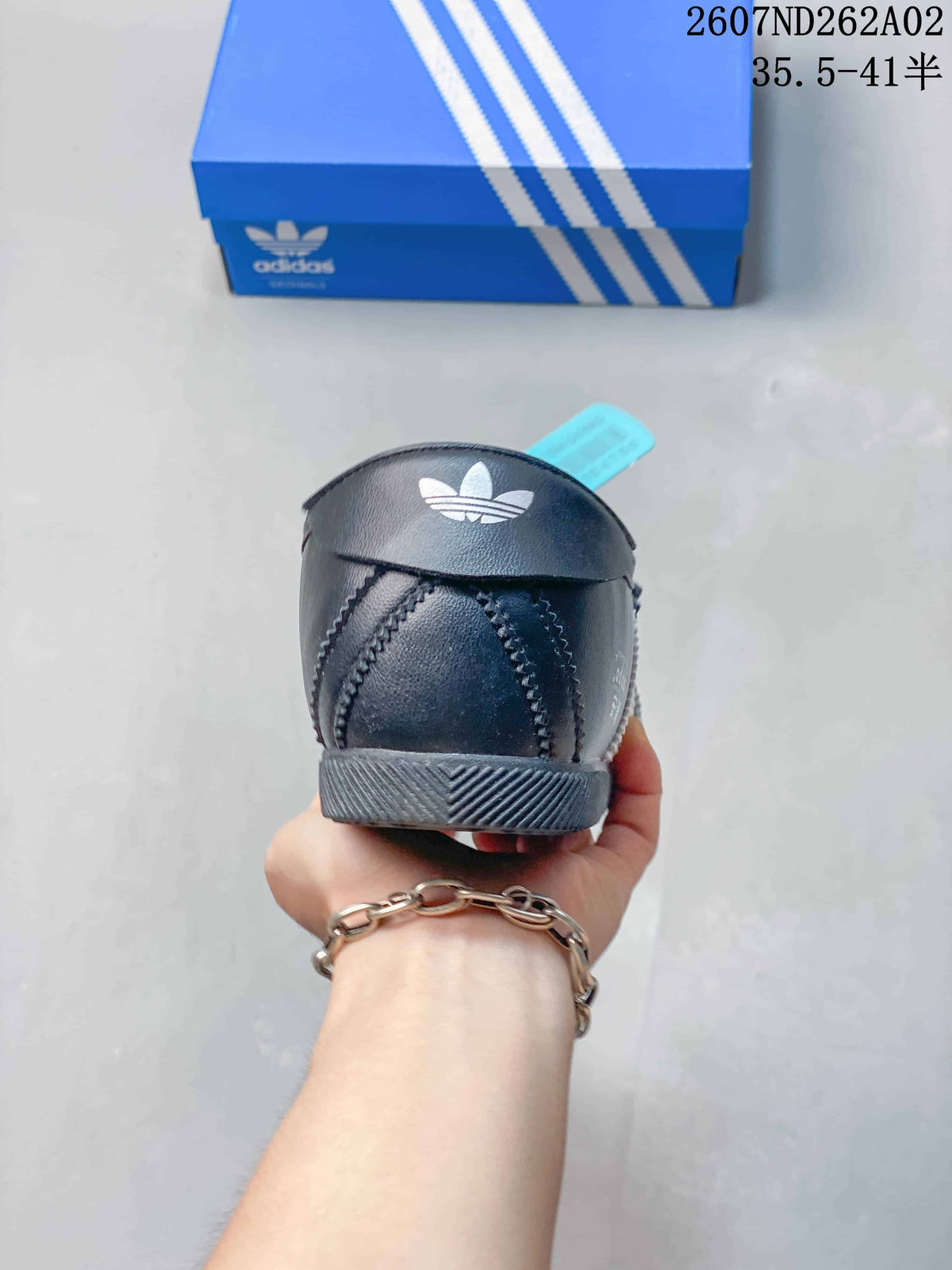 Rear view of the black adidas Originals ANFU MJ sneaker with trefoil branding