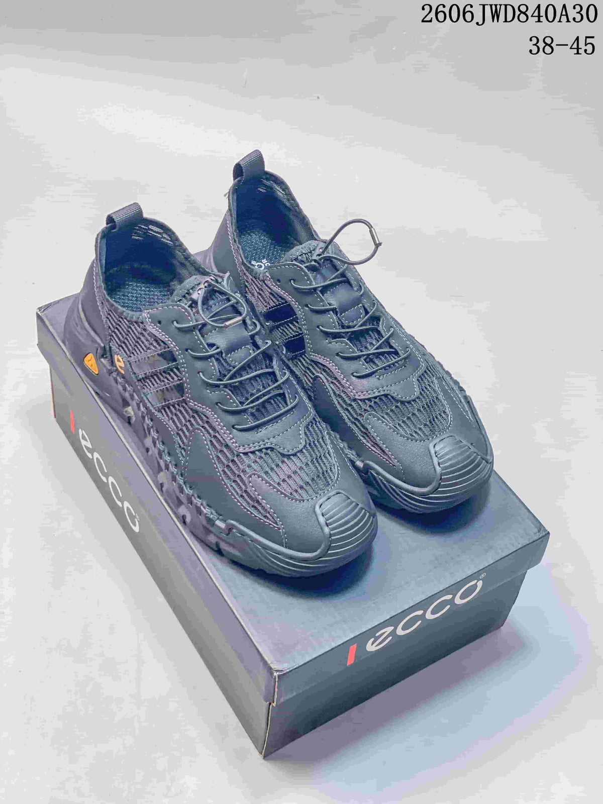 Pair of charcoal ECCO lace-up sneakers displayed on a shoebox