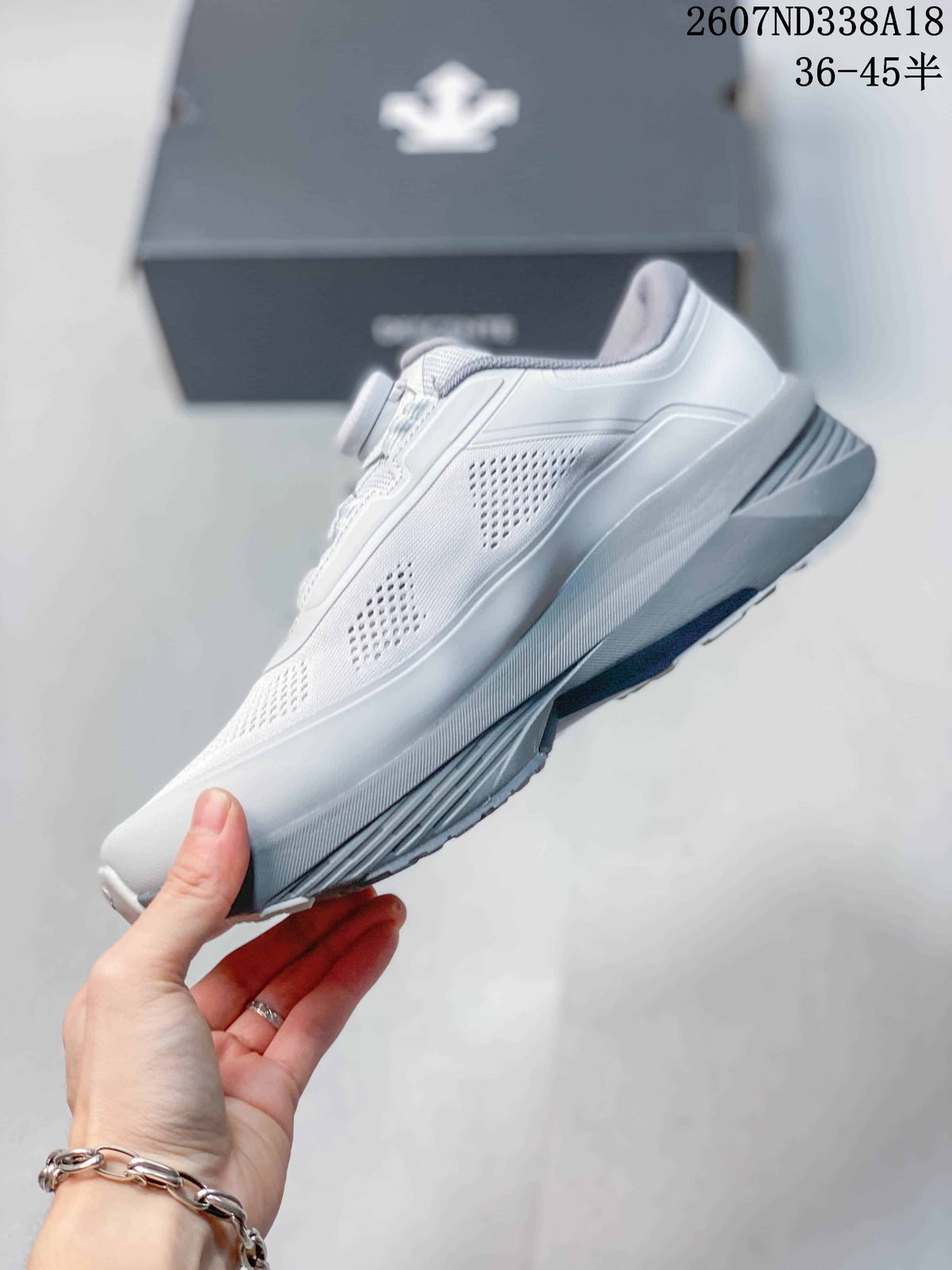 Side view of the low-top sneaker showing the perforated upper, sculpted midsole, and heel structure.