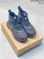Pair of dark gray LOEWE x On Cloudtilt high-top sneakers displayed on a tan shoebox, with the 36-46 size range and source code visible at the top.