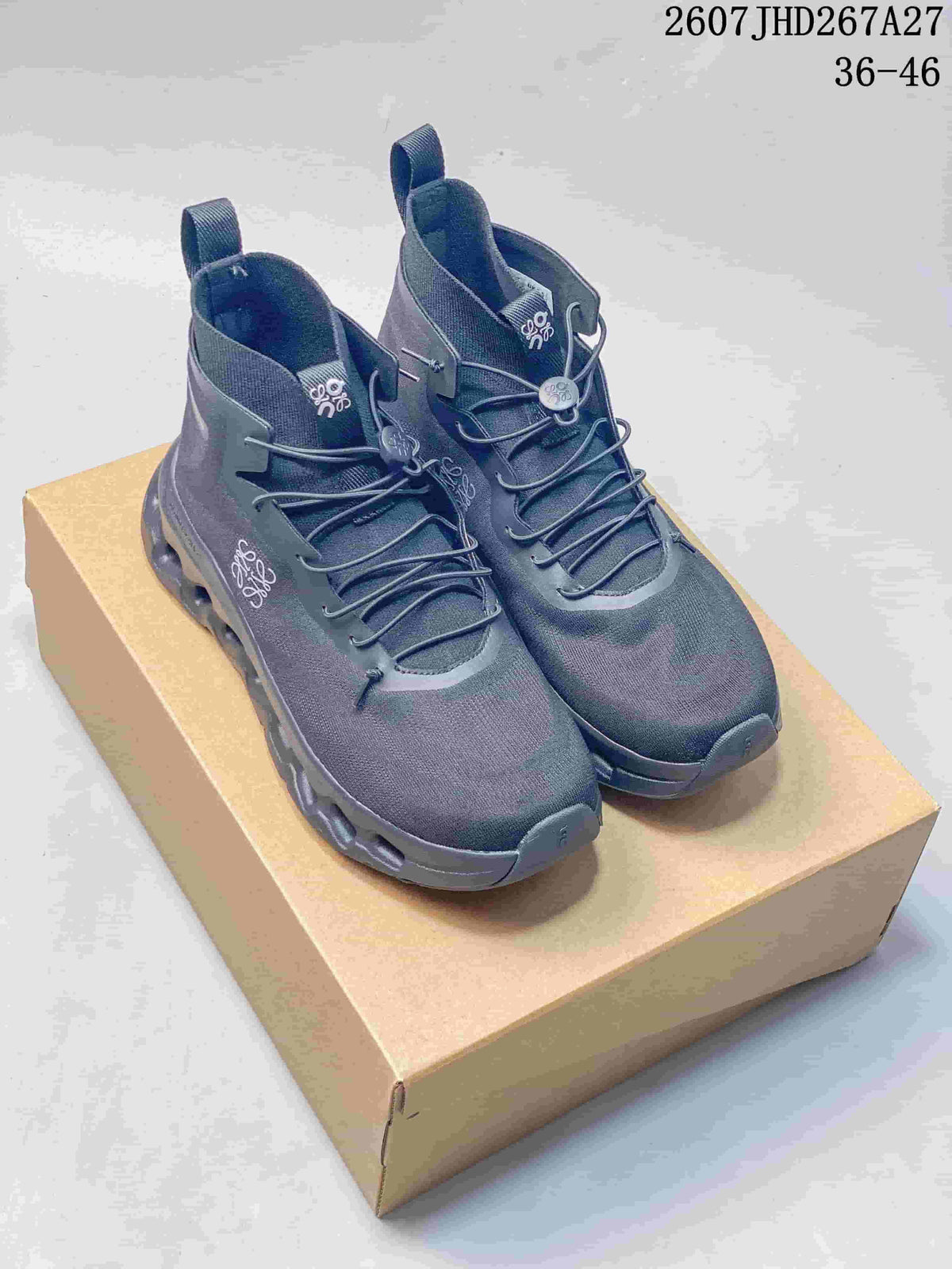 Pair of dark gray LOEWE x On Cloudtilt high-top sneakers displayed on a tan shoebox, with the 36-46 size range and source code visible at the top.