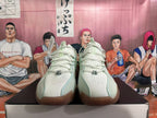 Front view of pale green and white Nike G.T. Jump 2 shoes with perforated uppers and brown-toned outsole sections