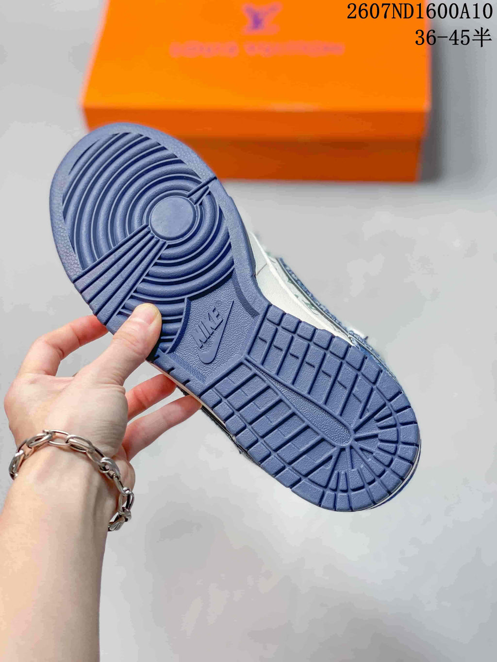 Close-up of the blue rubber outsole showing circular and grid-like traction patterns with Nike branding.