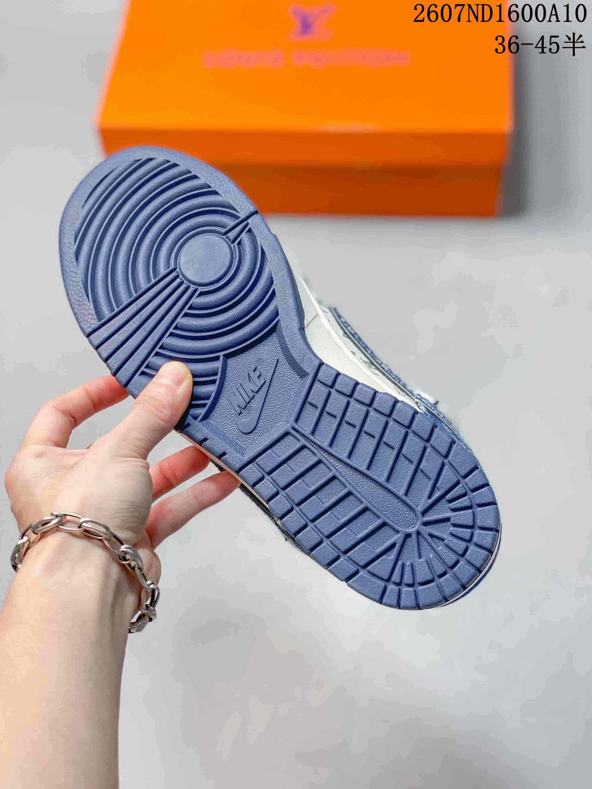 Close-up of the blue rubber outsole showing circular and grid-like traction patterns with Nike branding.