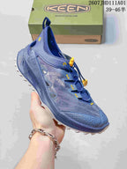 Angled side view of the blue hiking shoe with open mesh panels