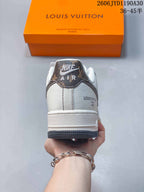 Heel view showing cream panels, a patterned heel tab, and dark gray outsole.