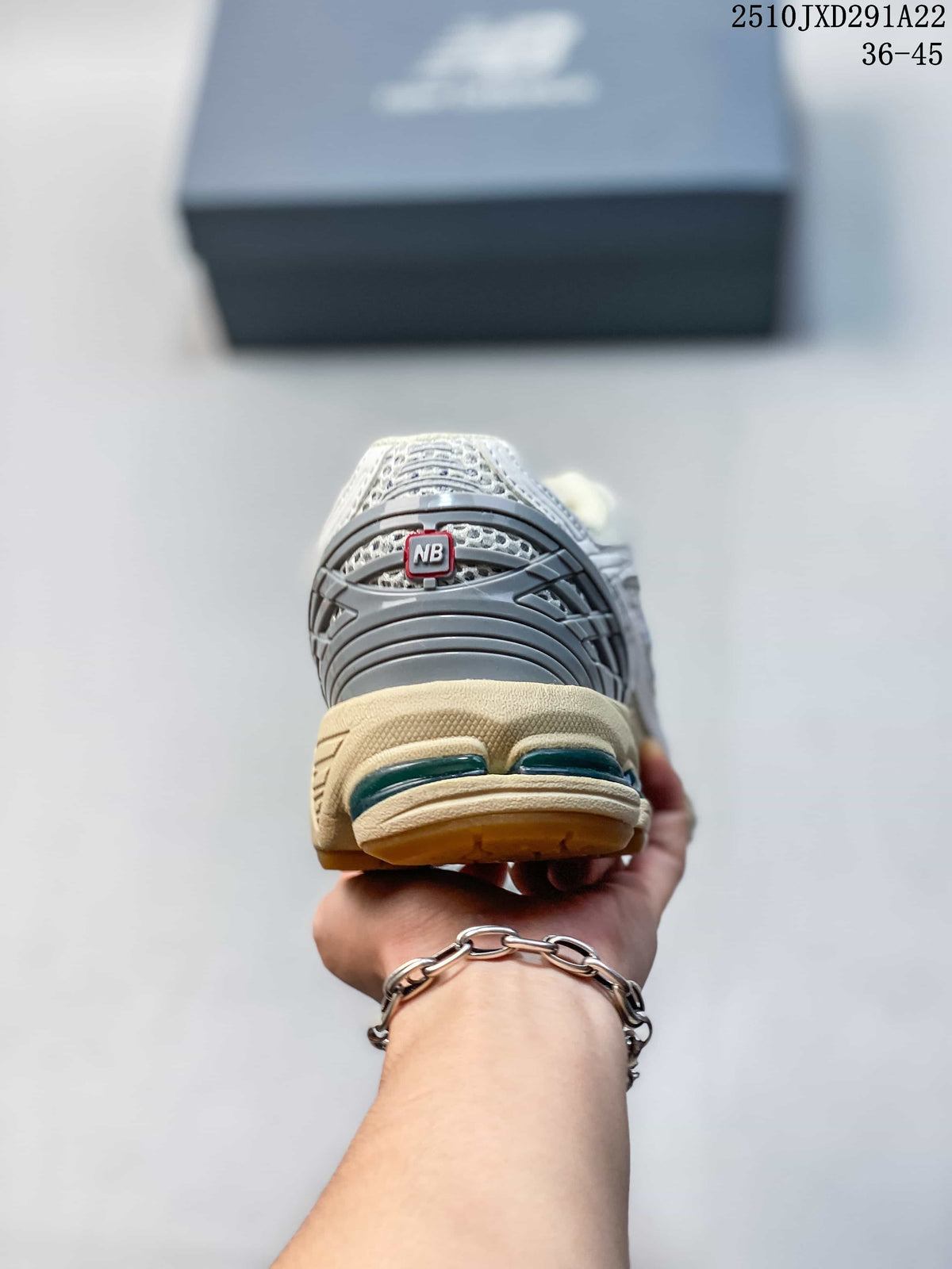Rear view of a New Balance 1906AD sneaker showing the gray heel panel and cream midsole; image also shows the printed size range 36–45.