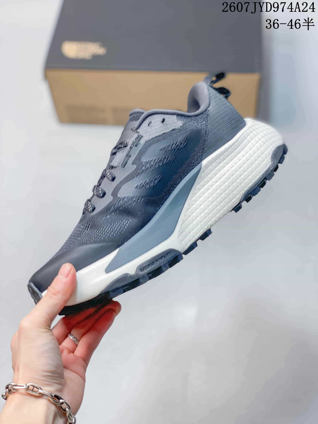 Side view of a dark gray Altamesa 500 sneaker showing the layered upper, lace system, white midsole, and lugged outsole.