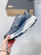 Side view of a dark gray Altamesa 500 sneaker showing the layered upper, lace system, white midsole, and lugged outsole.