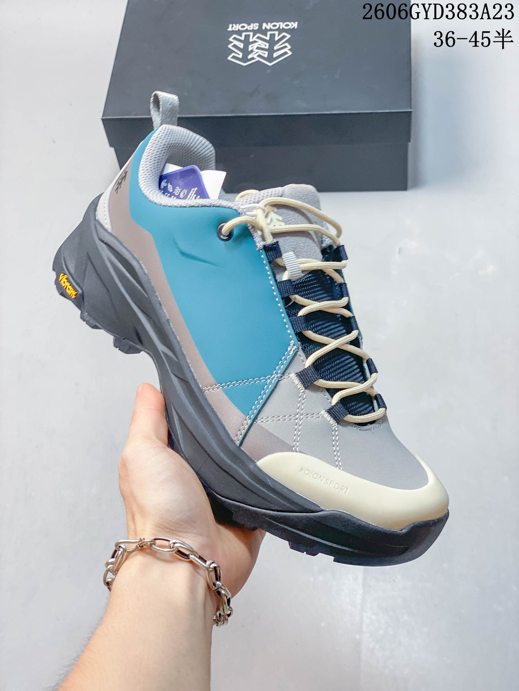 Side view highlighting the teal panels and rugged outsole