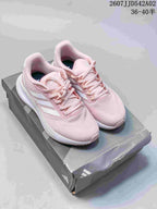 Pair of pink Adidas Runfalcon 5 shoes on a shoebox, viewed from above.