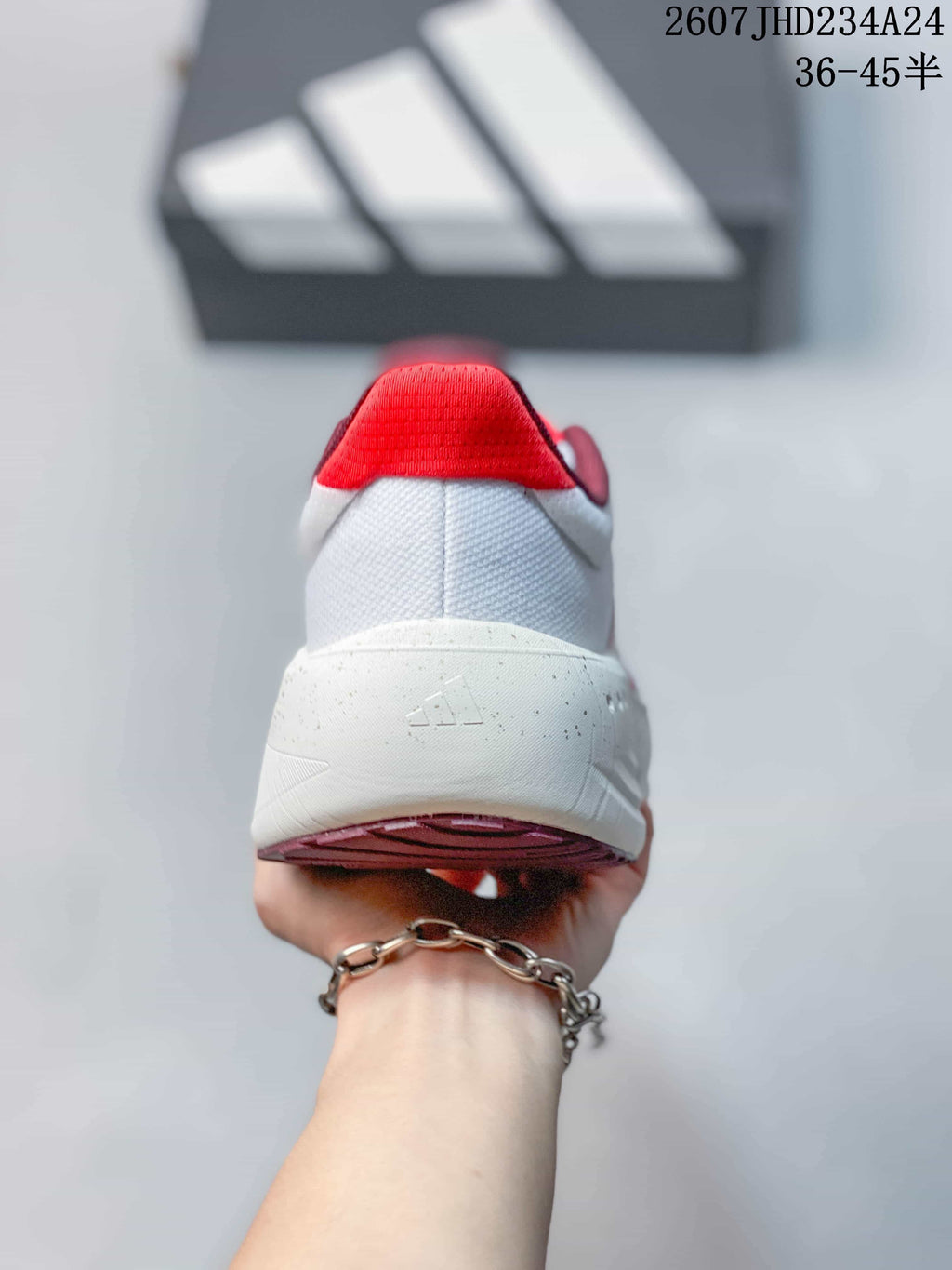 Rear view showing the white heel, red heel collar and embossed adidas mark on the midsole.